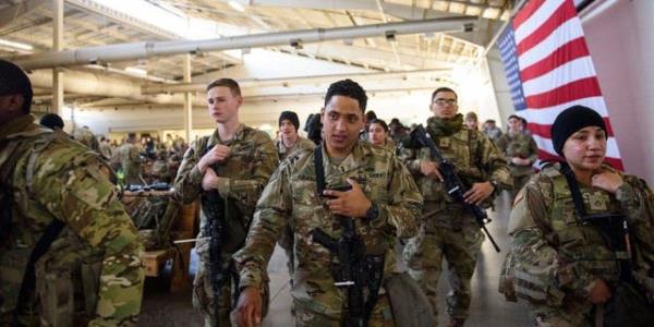 Soldiers of the 82nd Airborne Division listen to instructions prior to their deployment to Poland on February 14, 2022 at Fort Bragg, Fayetteville, North Carolina ahead of Russia's invasion of Ukraine.